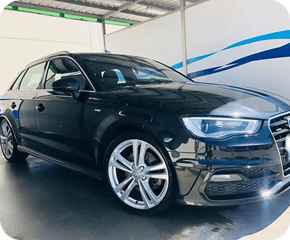 Vehículo eléctrico negro en estación de carga ECOBOX, ecológico y eficiente.